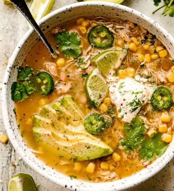 Bowl of Crock Pot white chicken chili garnished with cilantro and lime.