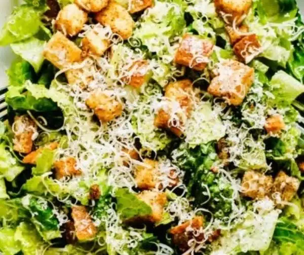 Delicious and fresh Caesar salad garnished with croutons and parmesan cheese