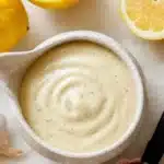 Homemade Caesar salad dressing in a bowl with fresh ingredients