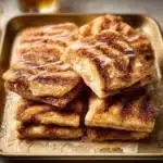 Delicious cinnamon roll pancakes baked in a sheet pan, ready to serve.