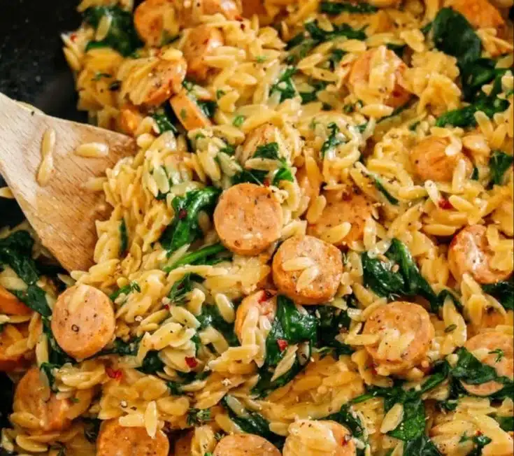 Creamy chicken sausage orzo skillet served with fresh herbs