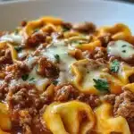 One pan beefy tortellini bake with cheese and ground beef in a casserole dish