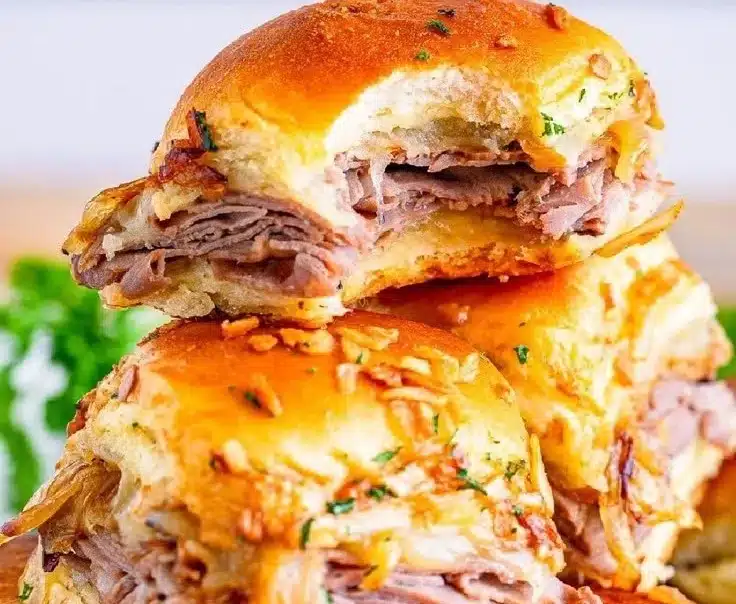Delicious French dip sliders with beef and cheese served with au jus for dipping.