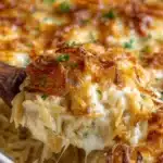 Delicious French Onion Chicken Orzo Casserole topped with melted cheese