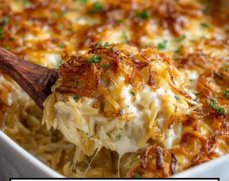 Delicious French Onion Chicken Orzo Casserole with melted cheese and fresh herbs