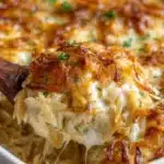 French Onion Chicken Orzo Casserole topped with cheese and herbs