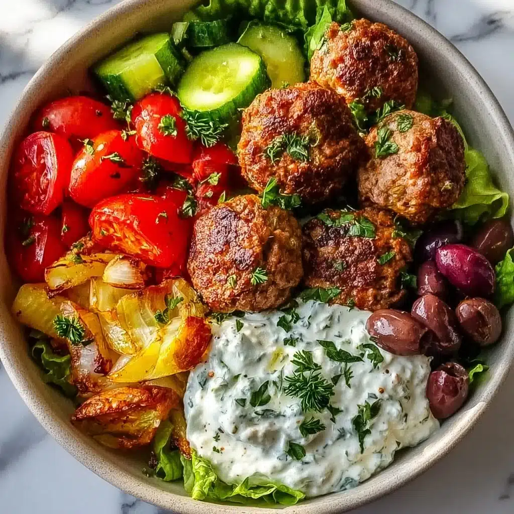 Mediterranean-inspired Greek meatball bowl with fresh ingredients.