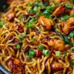Delicious sticky garlic chicken noodles served in a bowl