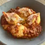 Plate of delicious stuffed shells with cheese and tomato sauce