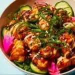 Delicious Bang Bang Chicken Bowl served with vibrant vegetables and spicy sauce