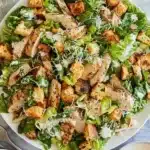 Delicious Chicken Caesar Salad topped with homemade croutons and fresh ingredients.