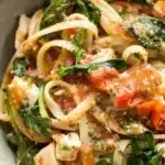 Bowl of Chicken Feta Spinach Pasta garnished with herbs