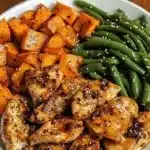 Deliciously cooked honey garlic chicken served with sweet potatoes on a plate