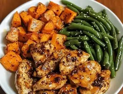 Deliciously cooked honey garlic chicken served with sweet potatoes on a plate
