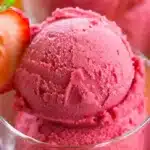 Bowl of easy 3 ingredient strawberry sorbet garnished with fresh strawberries