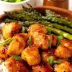 Homemade honey mustard chicken served with asparagus on a plate