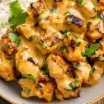 Delicious Thai Peanut Chicken garnished with peanuts and herbs