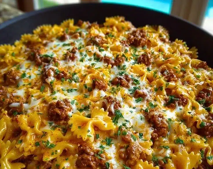 Cajun Cream Cheese Alfredo Bowties with Spiced Ground Beef served in a bowl