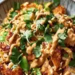 Delicious Chicken Crispy Rice Salad topped with peanut dressing