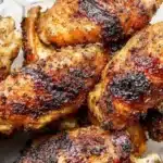 Crispy grilled chicken wings served on a platter with dipping sauce