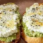 Easy cottage cheese avocado toast topped with fresh herbs and spices