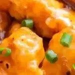 Delicious crockpot orange chicken topped with sweet and tangy sauce