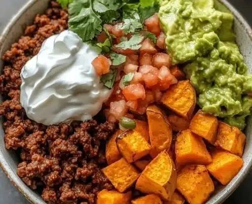 Colorful Sweet Potato Taco Bowl garnished with fresh vegetables and toppings