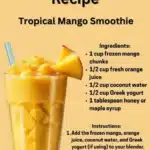 Tropical mango smoothie in a glass with fresh mango slices