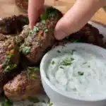 Delicious homemade kafta served with fresh herbs and spices on a plate.