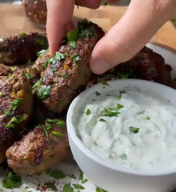 Delicious homemade kafta served with fresh herbs and spices on a plate.